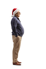 Full length profile shot of a mature man wearing a santa claus hat