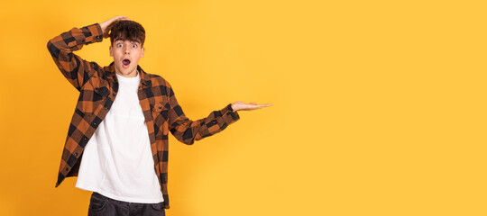 isolated teenager pointing with astonished expression
