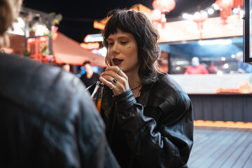 Happy caucasian woman sitting with her boyfriend at the street cafe