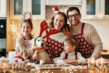 Happy family parents with two kids and golden retriever puppy while making xmas cookies at home