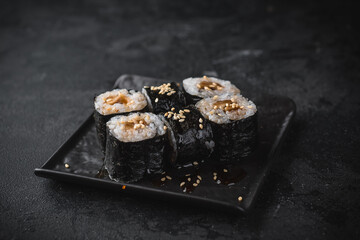 sushi on a black plate