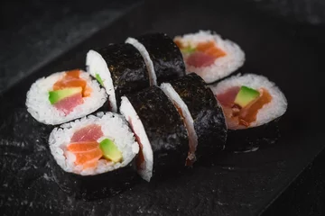 Fotobehang sushi on a black plate futo maki © Vladimir