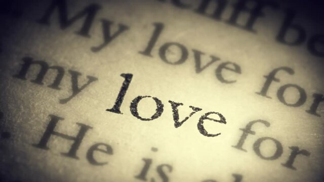 The word Love on the old page in the book is separated from the general text and zooms into the camera. Creative 3D 4k slow motion video animation.