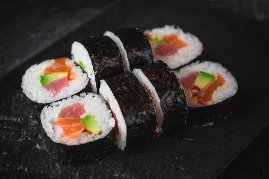 sushi on a black plate futo maki
