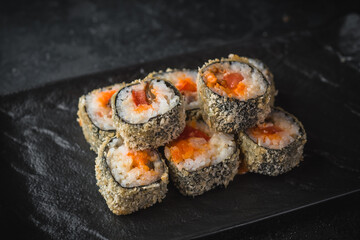 hot sushi roll on a black plate © Vladimir