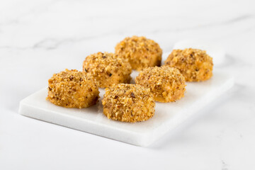 Nut cookies on a serving board on a white background
