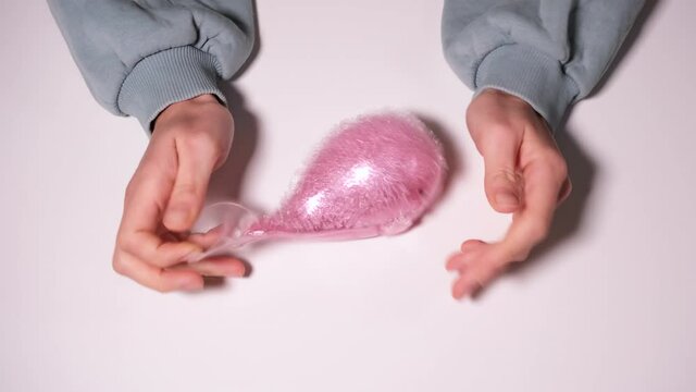 Hand play with Squeeze pink fish Hand Wrist Exercise Antistress Toy. Stress Relief toy isolated on white background. 4k resolution video.
