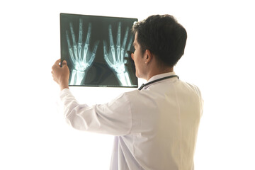 Asian male doctor holds a brain X-ray film where CT scans the patient and analyzes the results while discussing medical problems with the patient lying in bed next to him on white background.