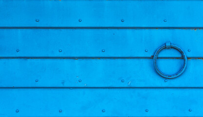 Blue rippled metal background. The texture of horizontal metal plates connected by rivets. Blank for a poster or banner.