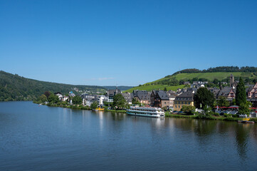View on Mosel river, hills with vineyards and old town Traben-Trarbach, Germany