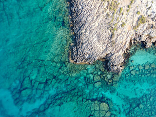 Crystal clear blue water of Mediterranean sea on Fig tree beach in Protaras, Cyprus, top view