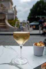 Drinking of brut champagne sparkling wine in street cafe in old central part of city Reims, Champagne, France