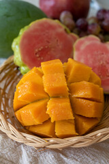 Exotic fruits of Cyprus, fresh yellow juicy mango, ripe pink guava, bananas and sweet table grapes