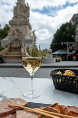 Drinking of brut champagne sparkling wine in street cafe in old central part of city Reims, Champagne, France