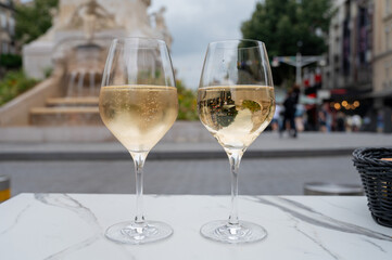 Drinking of brut champagne sparkling wine in street cafe in old central part of city Reims, Champagne, France