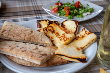 Traditional roasted or grilled halloumi cheese from Cyprus served hot with flat bread