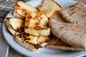 Traditional roasted or grilled halloumi cheese from Cyprus served hot with flat bread
