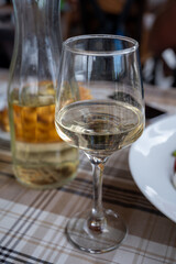 Dinner with white wine in small Greek taverna