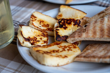 Traditional roasted or grilled halloumi cheese from Cyprus served hot with flat bread