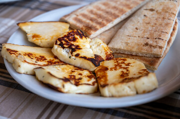 Traditional roasted or grilled halloumi cheese from Cyprus served hot with flat bread