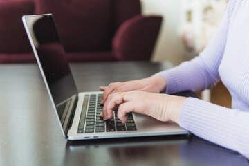 person hands typing on laptop on desk