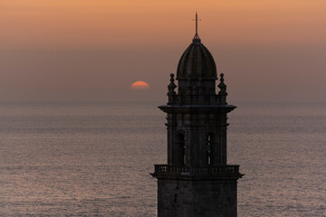 Sunset behind bell tower of the Monastery of Oia, Galicia. - obrazy, fototapety, plakaty