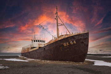 old boat stranded on nordic beach in winter