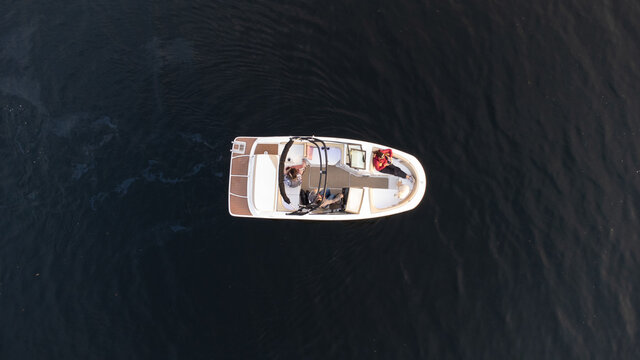 Aerial view of boat on dark water of lake in Ontario, Canada.