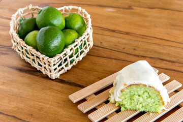Lemon cake with lemons on wooden background.