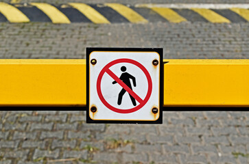 Don't cross pictogram on vehicle security barrier in residential condominium, Rio