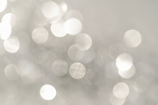 Abstract white and silver background with bokeh.
