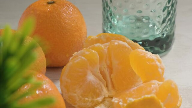 Tilt down Orange Mandarin fruits with juice glass on White table - Heathy Nutrition