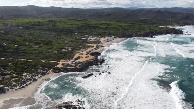 massive waves on sardinia's northwest coast in rena majore, nice weather (with drone)