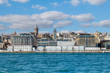 Fototapeta premium Istanbul cityscape with Galata tower in the background. City view of Karakoy and Galata district of Istanbul seen from Bosphorus, the strait of Istanbul.