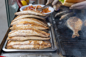 Grilled fish in Istanbul. Grilled mackerel for the popular street food in Turkey, Balik Ekmek, a Turkish fish sandwitch.