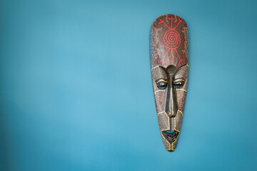 Tribe mask on the wall. African tribal mask, wooden black mask of indigenous people