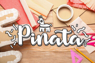 Preparation of Mexican pinata on wooden background