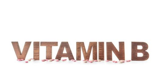 Text VITAMIN B with pills on white background