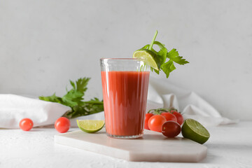 Board with glass of bloody mary on table
