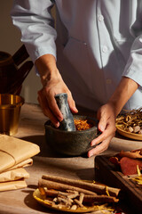 Traditional chinese medicine with herb and spices in brown wooden background doctor using mortar and pestle for advertising ,  traditional content 