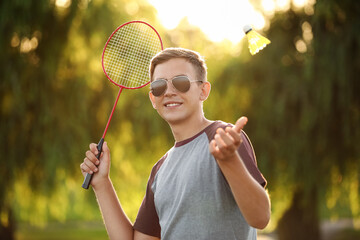 Young man playing badminton  outdoors