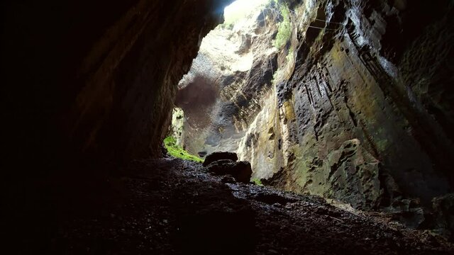 Amazing view inside a big natural cave with bats in Malaysia. Wide angle view of cave and a lot of bats go out and go in