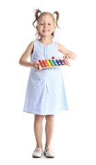 Adorable little girl with xylophone on white background