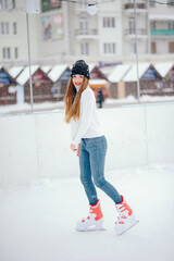 Cute and beautiful girl in a white sweater in a winter city