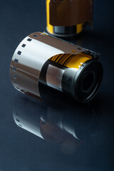 A closeup of an old 35mm film roll with s mall strip of film on the outside.