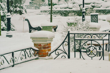 First snow in the park. Snowfall in city park, snow plow in distance.