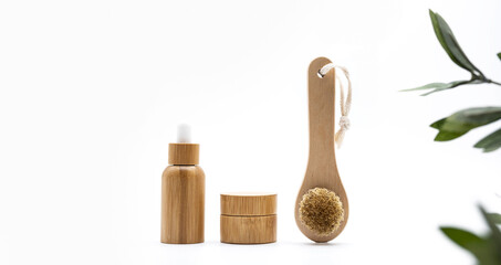 Fototapeta na wymiar Bath bamboo brush, eco-friendly bamboo bottle and jar. Set of natural cosmetic products. Zero waste. No plastic concept.