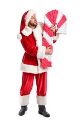 Happy Santa Claus with candy cane pinata on white background