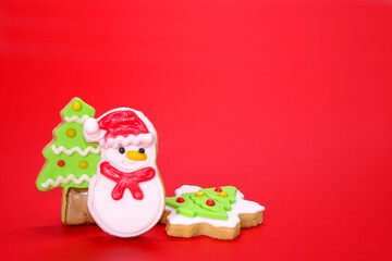 Christmas cookies on red background, Christmas greeting card with cute and colorful Christmas cookies on red background, copy space. Xmas 
