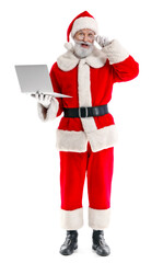 Surprised Santa Claus with modern laptop on white background